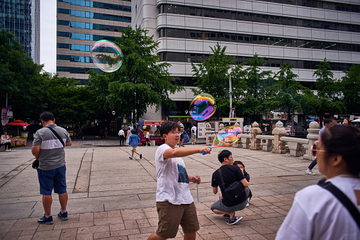 Seoul, Republic of Korea - June 10, 2018 - Children have fun on the street with soap bubbles