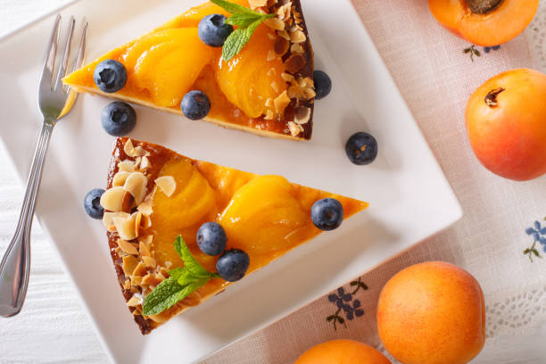 istock Apricot cake with blueberries, mint and nuts close-up on a plate. horizontal top view 996659326