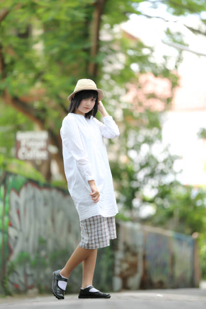 istock Asian young woman thinking and looking portrait with green tree background 996662814