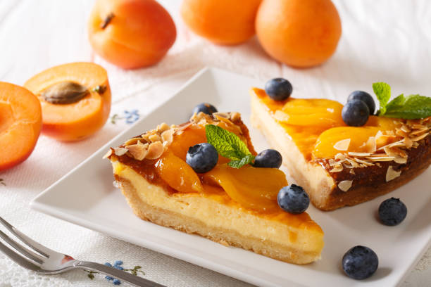 istock Beautiful apricot cheesecake with blueberries, mint and nuts close-up. horizontal 996663610