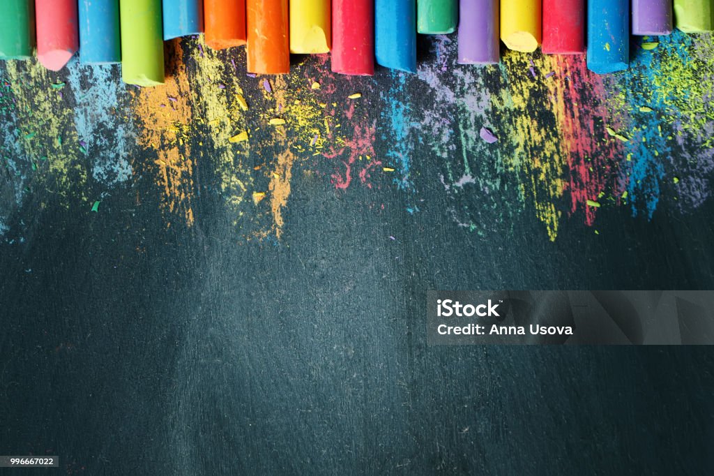 Colorful crayons on the blackboard, drawing. Back to school background Colorful crayons on the blackboard, drawing. Back to school background. Selective focus. Background with copy space. Backgrounds Stock Photo