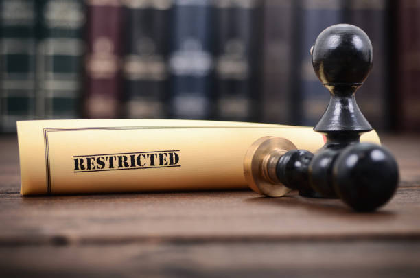 istock Restricted document and notary seal on the wooden background. 996669266