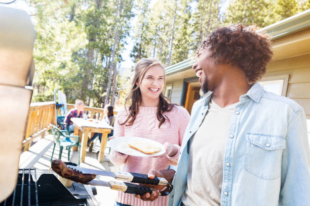 istock Young man serves hot dog to friend 996670108
