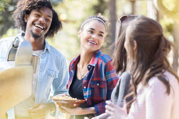 istock Young adults laughing together outdoors 996670158
