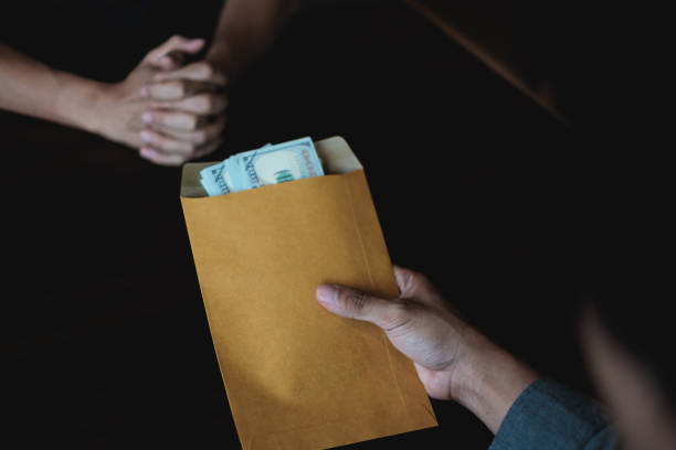 istock Business Man Rejecting black money in envelope that offered by contractor for permit in contract. Corruption and Anti Bribery concepts. 996672722