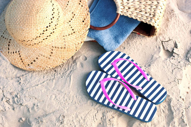 istock Beach items with accessories  on sand summer background 996676056