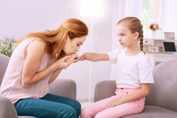 istock Pleasant anxious woman kissing her daughters hand 996676832