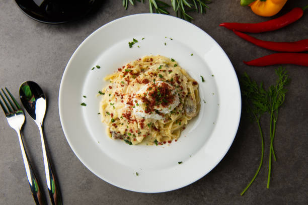 istock Pasta carbonara and poach egg and chicken flat lay view 996679162