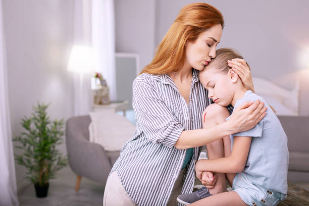 istock Pleasant loving mother kissing her child 996680128
