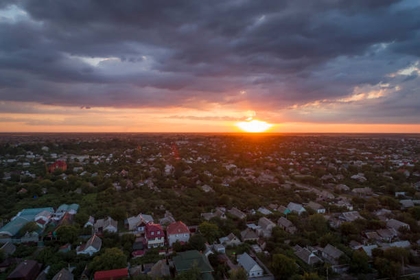Aerial view of residential houses neighborhood and apartment building complex at sunset. Aerial view of residential houses neighborhood and apartment building complex at sunset. melitopol stock pictures, royalty-free photos & images