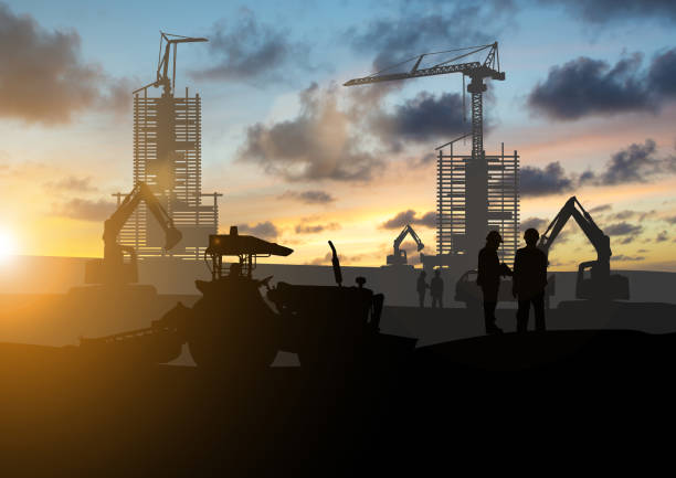 istock Silhouette of engineer and construction team working at site over blurred background sunset pastel for industry 996692350