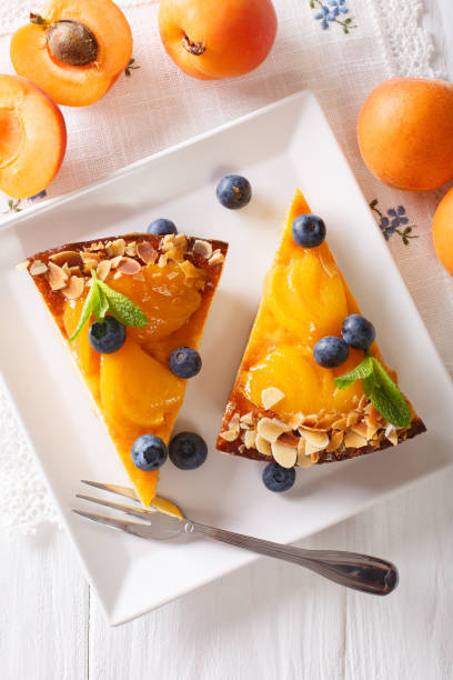 istock Apricot pie with blueberries and nuts close-up on a plate. Vertical top view 996692662