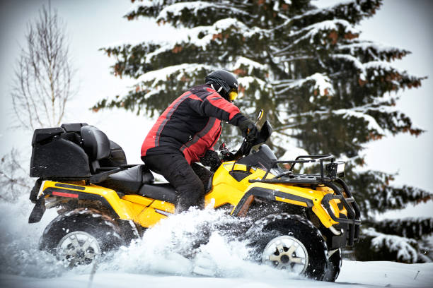 istock Winter race on an ATV on snow in the forest. 996710126