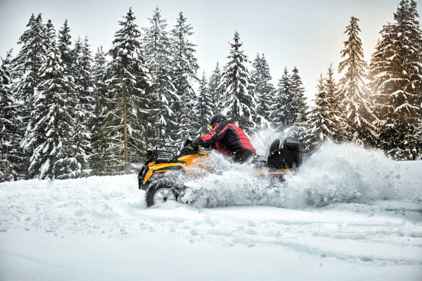 istock Winter race on an ATV on snow in the forest. 996710128