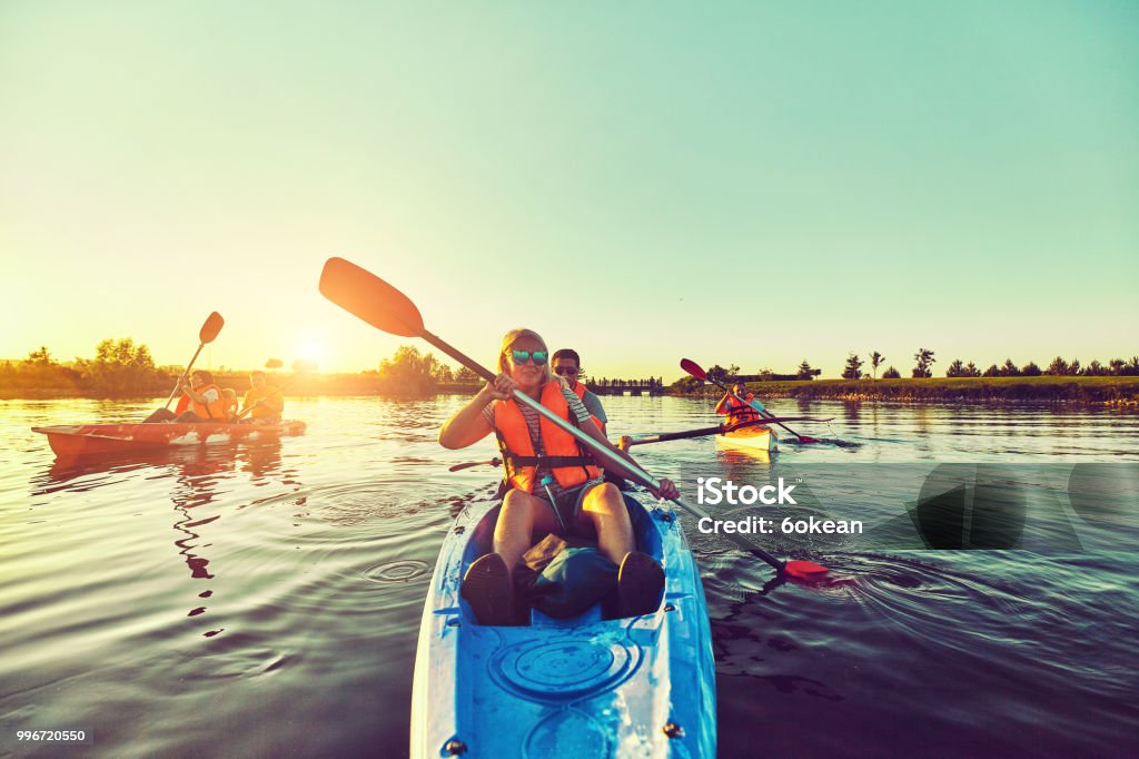 Wild nature and water fun on summer vacation. Camping and fishing. Kayaking and canoeing with family. Children on canoe. Family on kayak ride. Family Stock Photo