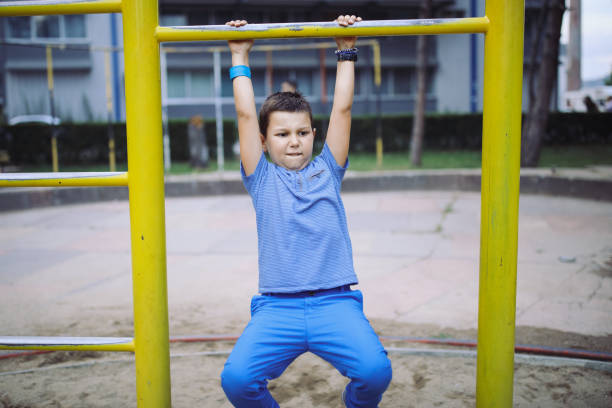 istock Boy having fun on the monkey bars at the playground 996721164