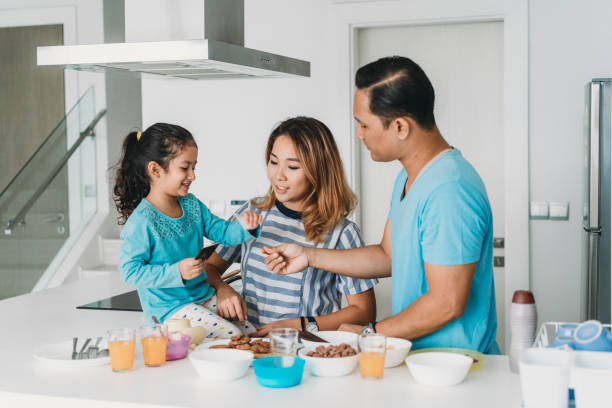 istock Affectionate family preparing breakfast at home 996721740