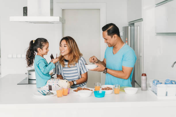 istock Affectionate family preparing breakfast at home 996721742
