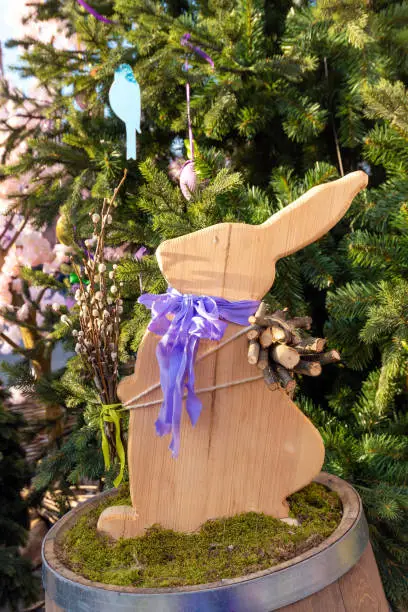 Photo of Cute wood rabbit and easter eggs hanging on tree decorate  during the season of Eastertide.