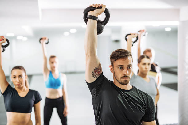 istock Young personal trainer exercising with girls in gym 996727408