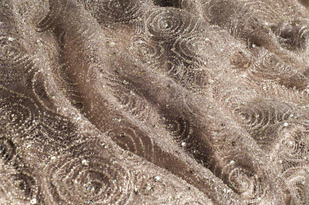 istock Texture, fabric, background. Lace fabric with a pattern of a circle, with a thread of gold thread 996728330