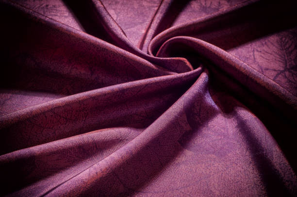 istock Texture, background, pattern. fabric silk dark maroon. Silk organza mood, but with a beautiful satin face. This fabric has a crunchy drape of organza, but one face is a brilliant satin. 996728354