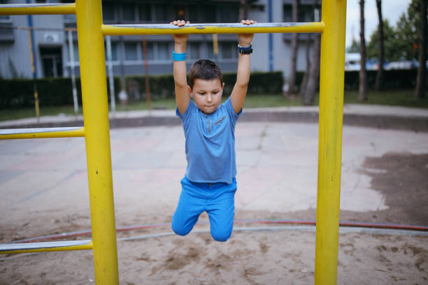 istock Boy having fun on the monkey bars at the playground 996733630