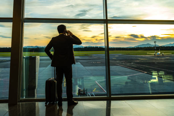 istock Businessman talking on mobile phone at airport 996734440
