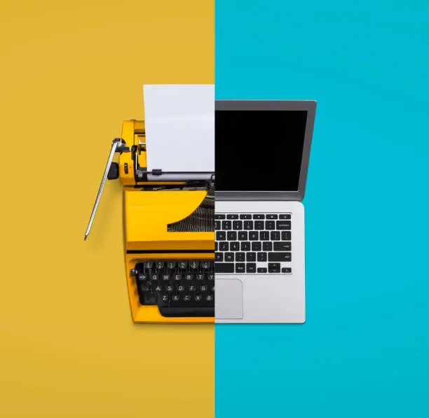 Typewriter versus laptop computer concept old vs new