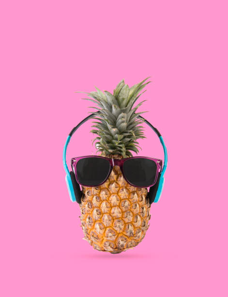 istock Pineapple with sunglasses and headphone on pink background. fruit summer concept. 996754142