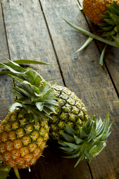 istock Pineapples eruit on wooden background 996758586