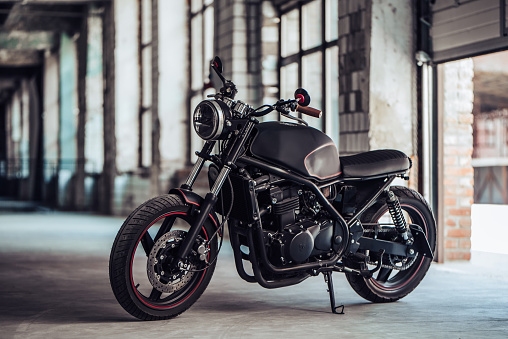 Modern black motorcycle in garage. Cafe racer.