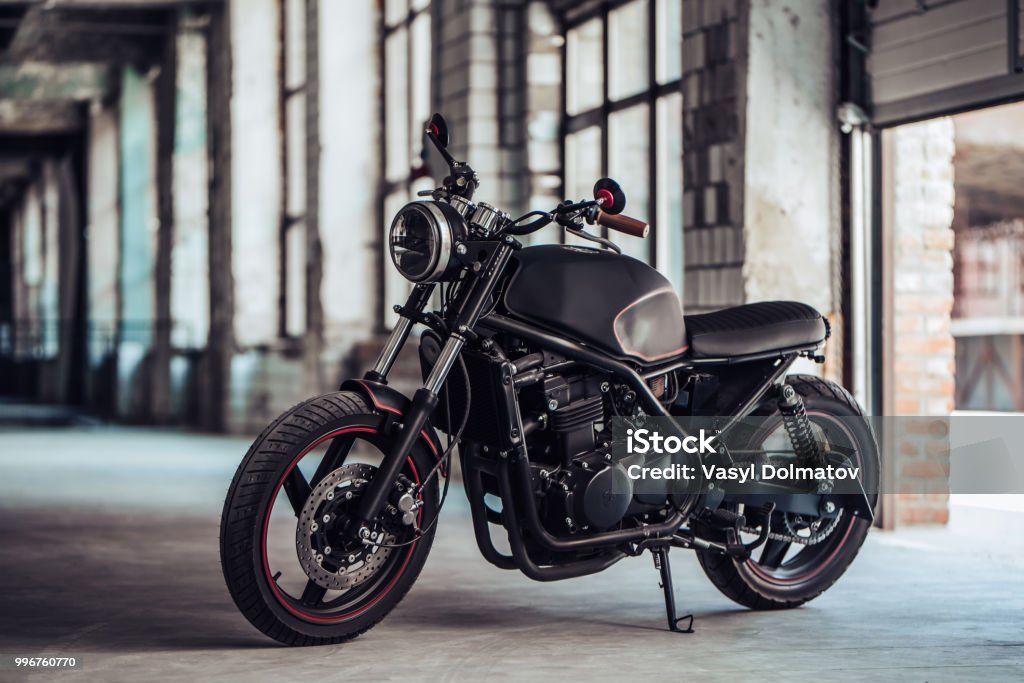 Modern black motorcycle Modern black motorcycle in garage. Cafe racer. Motorcycle Stock Photo