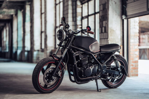 Modern black motorcycle Modern black motorcycle in garage. Cafe racer. electric motor photos stock pictures, royalty-free photos & images