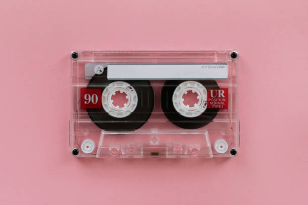 istock Audio cassette - analogue audio storage media. Audio cassette on pink background 996762380