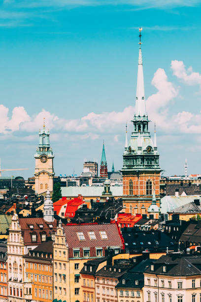 stockholm, sweden. historical center with tall steeple of the german church or st. gertrude's church in gamla stan, the old town in central part of swedish capital in summer - stadsholmen imagens e fotografias de stock