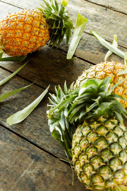istock Pineapples eruit on wooden background 996762452