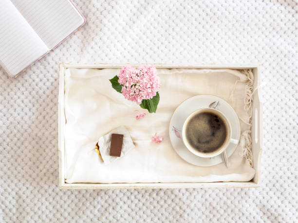 istock Cup of coffee on a white serving tray 996765102