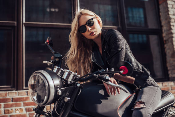 istock Woman with black motorcycle 996765544