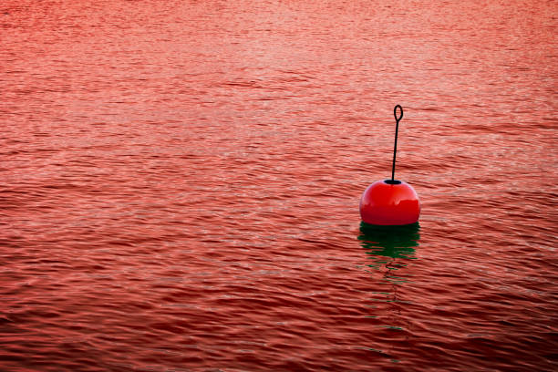 istock Red bouy on a calm bloody lake - concept image with copy space