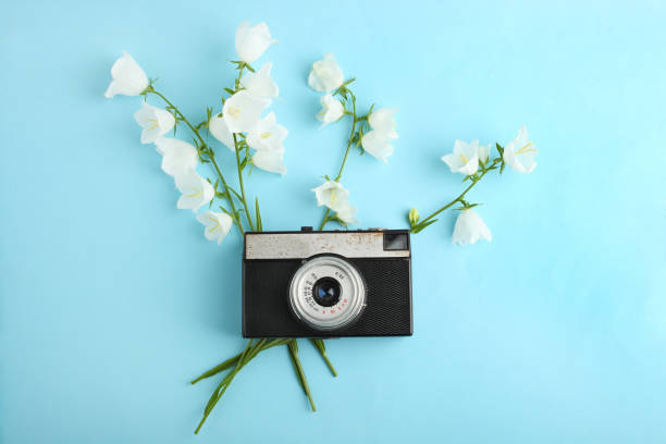 istock Beautiful white flowers bells and retro camera 996766298