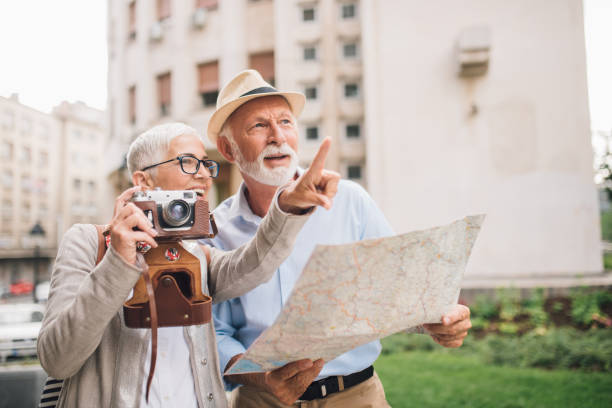 istock Elderly female tourist with camera pointing something to her husband 996773910