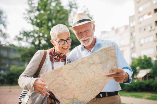 istock Elderly joyful couple looking at the map 996776032