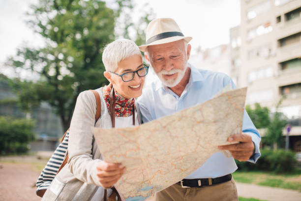 istock Mature couple examining touristic map together 996776034