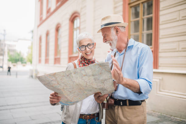 istock Happy couple looking at touristic map and smiling 996776120