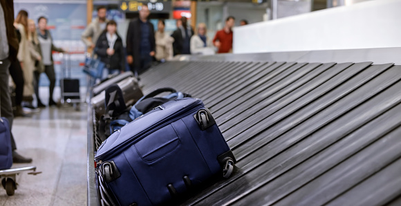 Business people standing at baggage claim in airport.