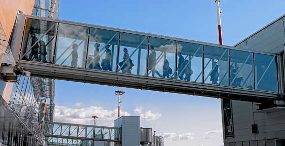 Business people walking on elevated walkway.