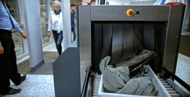 Airport security Checking baggage on conveyor belt at airport. metal detector security stock pictures, royalty-free photos & images