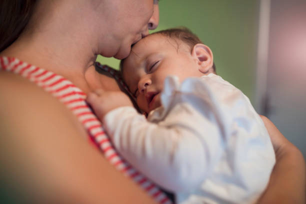 istock Little baby girl in mother arms 996813402