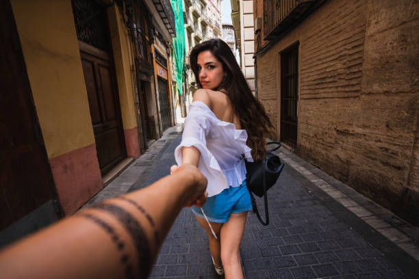 istock Young woman leading by hand and looking at camera 996813406